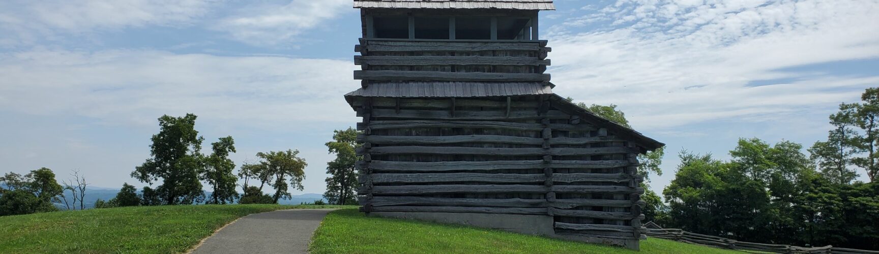 Log cabin structure against blue sky