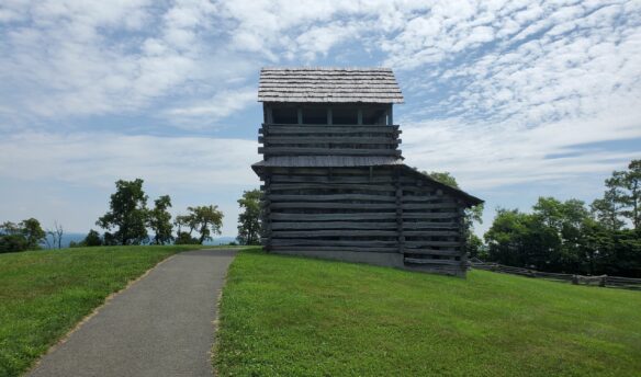 Log cabin structure against blue sky