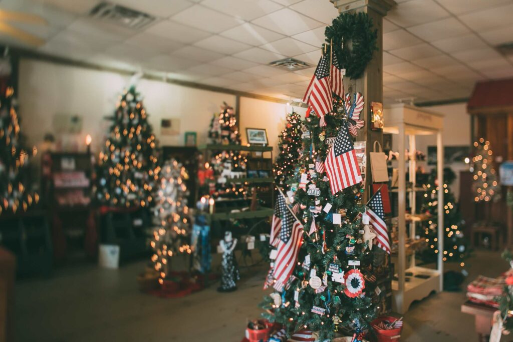 Christmas trees in a store with American flags and white lights